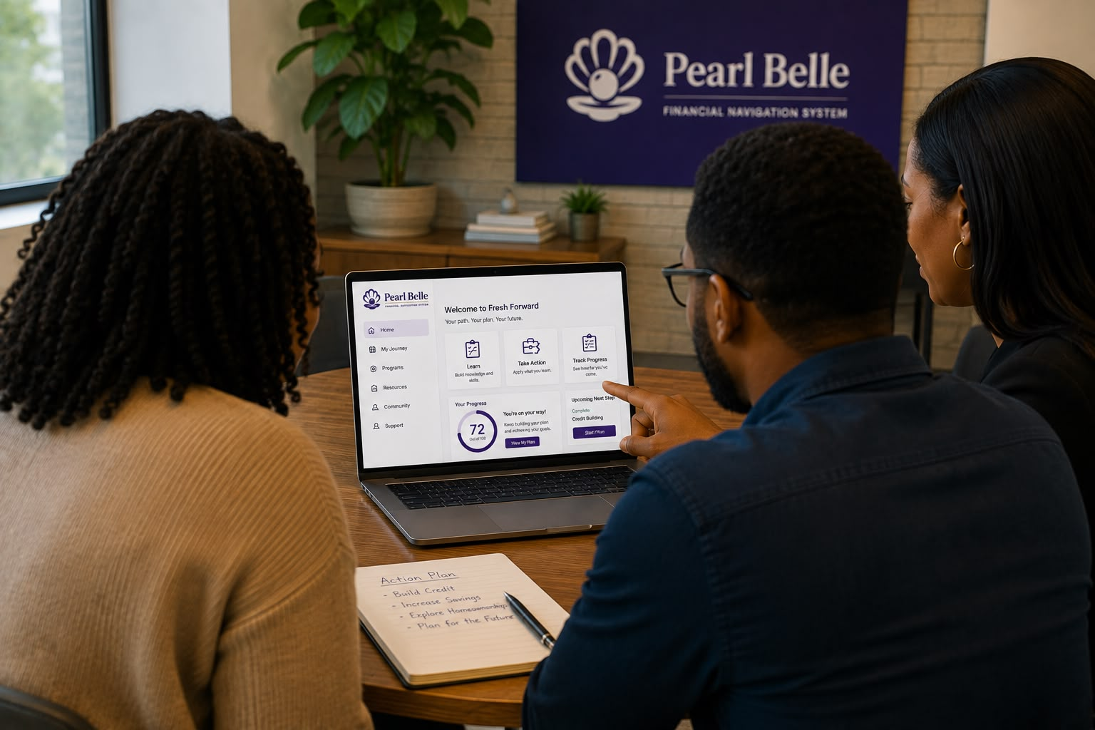 Team reviewing the Pearl Belle Financial Navigation System on a laptop