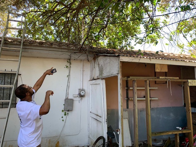 Homeowner standing outside a home undergoing repairs